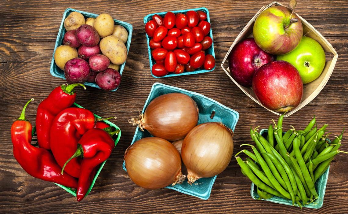 Fresh fruits and vegetables on a wooden table.